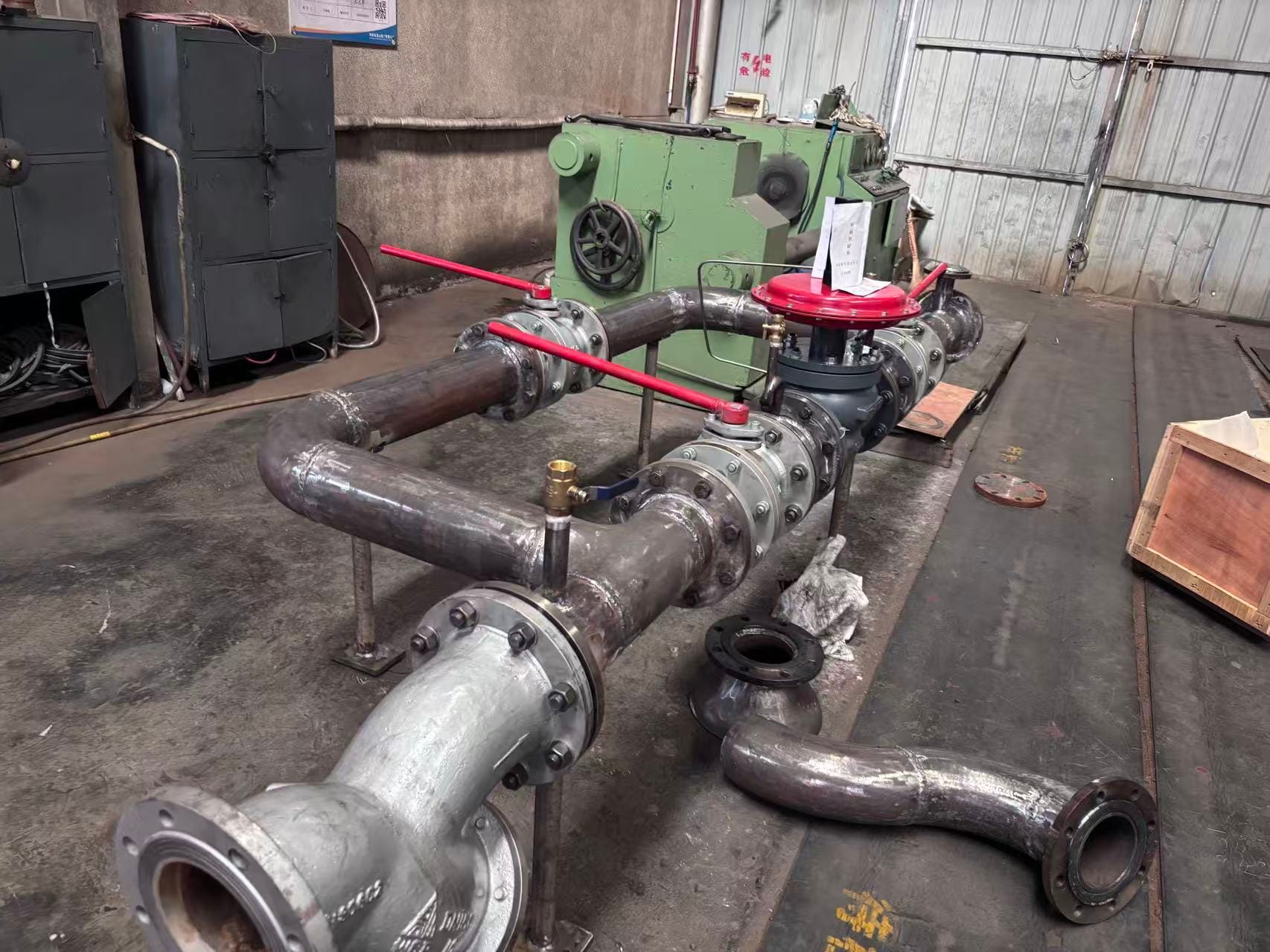 PRODUCT RELEASE | INDUSTRIAL STEAM SYSTEMS DN125 Steam Pressure Reducing Valve Station: Engineered Control for High-Pressure Steam Networks A factory-assembled, pre-piped pressure management solution delivering precise downstream pressure regulation, condensate elimination and system protection in a single, installation-ready skid. Overview Steam is one of the most widely used heat-transfer media in modern industry. However, boiler systems and long-distance steam mains operate at pressures far exceeding what most end-use processes can safely tolerate. Delivering steam at the correct pressure — consistently, reliably and safely — is both a process requirement and a safety imperative. The DN125 Steam Pressure Reducing Valve Station (PRV Station) is a fully integrated skid assembly designed and manufactured to address exactly this challenge. Combining a steam separator, primary isolation valves, a Y-type strainer, a spring-loaded pressure reducing valve, a safety relief valve and instrumentation into one pre-engineered unit, the station eliminates the complexity and risk of field-assembled pressure management systems. With a nominal pipe diameter of DN125 (5 inches) and a rated inlet pressure of up to 1.6 MPa (16 bar), this skid is sized for medium-to-large scale steam distribution applications across a broad range of industries. Application Scenarios The DN125 PRV Station is engineered for any environment where high-pressure steam must be reduced, conditioned and safely distributed to downstream equipment. Typical applications include: • Power generation plants — reducing main steam header pressure to turbine auxiliary systems, feedwater heating and steam-seal systems. • Petrochemical and refinery facilities — supplying process vessels, heat exchangers and reboilers with stable, low-pressure steam. • Pharmaceutical and food processing — providing clean, dry steam at precise pressures for sterilisation autoclaves, CIP systems and jacketed reactors. • District heating networks — stepping down high-pressure transmission steam to building-level heating systems. • Pulp and paper mills — feeding dryer cans, digesters and evaporators with regulated steam at defined pressures. • Textile and rubber manufacturing — supplying vulcanising presses and calenders with accurately controlled steam pressure. • Central utility plants and hospital complexes — managing multiple pressure zones from a single boiler source. Wherever a large differential exists between supply pressure and process requirement, this station provides the controlled transition. Component Breakdown and Function Every element within the skid has been selected and positioned to address a specific engineering requirement. The table below summarises each major component, its specification and its role within the assembly. Component Specification Function Steam Separator DN125, vertical shell Removes entrained condensate and water droplets from incoming steam, protecting downstream components from water hammer and erosion. Wet steam entering the skid exits as dry, saturated steam. Steam Trap Thermodynamic / Float type Continuously discharges condensate collected in the separator to drain without releasing live steam. Prevents condensate accumulation that would otherwise reduce heat-transfer efficiency and cause slug flow. Upstream Globe Valve DN125, rising-stem Primary isolation valve on the high-pressure inlet side. Allows safe isolation of the entire PRV train for maintenance or emergency shutdown without interrupting the bypass line. Y-Type Strainer DN125, 40-mesh screen Captures scale, pipe debris and particulate matter before it can reach the PRV seat. Maintains clean seating surfaces and extends valve service life. Fitted with a blowdown port for in-service cleaning. Pressure Reducing Valve (PRV) DN125, spring-loaded, self-acting The core control element of the assembly. Senses downstream pressure via a sensing line and modulates the valve plug position to maintain a constant, adjustable outlet set-point regardless of fluctuations in inlet pressure or downstream flow demand. Downstream Globe Valve DN125, rising-stem Outlet isolation valve on the low-pressure side. Enables the PRV to be isolated and serviced while the bypass valve maintains steam supply continuity. Bypass Globe Valve DN125, rising-stem, top-mounted Manually operated bypass circuit. During PRV maintenance or replacement, this valve is opened to route steam directly around the PRV train, ensuring uninterrupted production. Safety Relief Valve DN50, spring-loaded, 1.6 MPa set Final overpressure protection device on the low-pressure header. Opens automatically if downstream pressure rises above the rated set point, venting steam to a safe location and preventing catastrophic system failure. Upstream Pressure Gauge 0–1.6 MPa dial, glycerine-filled Provides continuous visual indication of inlet (high-side) steam pressure, allowing operators to monitor boiler supply conditions. Downstream Pressure Gauge 0–1.0 MPa dial (or as specified) Indicates the regulated outlet pressure in real time. Essential for confirming PRV set-point accuracy and detecting process demand changes. Engineering Challenges Addressed Field-built pressure management systems frequently suffer from a range of operational problems. The DN125 PRV Station has been designed from the ground up to solve each of these: 1. Water Hammer and Wet Steam Erosion High-velocity slugs of condensate in steam lines — commonly known as water hammer — can rupture pipework, damage valve internals and destroy instrumentation within seconds. The steam separator at the inlet eliminates entrained moisture before it can reach any sensitive components, while the steam trap removes accumulated condensate on a continuous basis. 2. Pressure Instability and Process Variability Fluctuating boiler pressure or varying process loads can cause downstream pressure to oscillate, resulting in inconsistent product quality and process upsets. The self-acting PRV maintains a constant outlet pressure across a wide range of inlet pressures and flow rates, decoupling downstream processes from supply-side variability. 3. Foreign-Particle Damage to Control Valves Pipe scale, weld spatter and corrosion products are pervasive in steam systems and are a primary cause of PRV seat leakage and premature valve failure. The Y-strainer positioned upstream of the PRV intercepts particles before they can score or wire-draw the valve plug and seat, substantially extending the service interval of the most expensive component in the assembly. 4. Overpressure Risk on Low-Pressure Headers PRV failure in the open position, or an accidental valve misoperation, can expose low-pressure equipment to full boiler pressure — a potentially catastrophic event. The safety relief valve on the outlet header provides a certified, independent last line of defence, automatically limiting downstream pressure to its set-point regardless of upstream conditions. 5. Maintenance Downtime and Production Loss In traditional in-line PRV installations, any maintenance activity requires a complete system shutdown. The factory-built bypass circuit incorporated into this skid allows the PRV to be isolated, serviced and returned to service without interrupting steam supply to the process, significantly reducing planned downtime. 6. Installation Cost and Quality Variability Field-assembled valve trains are subject to errors in component selection, layout and pipe fabrication quality. Delivering the station as a factory-built, hydrostatically tested skid eliminates site fabrication risk, reduces installation time by up to 60% and ensures repeatable engineering quality across multiple project sites. Operating Precautions and Maintenance Guidelines Correct commissioning, operation and maintenance are essential for safe, long-term performance. All personnel involved in the installation or operation of this equipment must be qualified in steam system safety practices and must comply with applicable national standards (e.g. GB 50316, ASME B31.1/B31.3 or EN 13480 as applicable). Pre-Commissioning Checks • Verify that all inlet and outlet pipe connections are aligned to the skid flanges without imposing bending moments or thermal stress on the skid pipework. • Confirm that pipe supports and anchor points comply with the piping isometric drawing and that thermal expansion loops are in place on connected pipework. • Inspect the strainer basket and PRV internals for transit damage or debris accumulation before introducing steam. • Confirm that the safety relief valve discharge pipe is routed to a safe vent location and is adequately supported and free-draining. • Verify that all instrument connections (pressure gauge impulse lines) are purged and open before start-up. Start-Up Procedure • Open the steam trap bypass valve (if installed) and allow the separator and pipework to warm through slowly for a minimum of 15 minutes to prevent thermal shock and water hammer. • With both main isolation valves closed, slowly crack open the upstream globe valve by no more than 10–15% of full travel. Allow pressure to equalise across the PRV. • Gradually open the upstream globe valve to the full-open position over a period of not less than 2 minutes. • Open the downstream globe valve and monitor the outlet pressure gauge to confirm the PRV is regulating at the pre-set outlet pressure. • Check all flanged joints, valve gland packings and instrument connections for leakage and tighten as necessary. • Once stable operation is confirmed, close the steam trap bypass (if applicable) and confirm trap operation. Routine Operation • Check pressure gauge readings at the start of each shift. Any deviation from the set-point pressure should be investigated promptly. • Inspect the safety relief valve seat area regularly for evidence of simmering or weeping, which may indicate the downstream pressure is approaching the set-point. • Blow down the Y-strainer at intervals specified in the maintenance schedule (typically every 1,000 operating hours or quarterly, whichever is sooner) to remove accumulated debris. • Test the steam trap operation by using a trap tester, an infrared thermometer or acoustic testing to confirm condensate is being discharged without live steam loss. PRV Bypass Operation • Before opening the bypass globe valve, confirm that downstream systems are rated for the unregulated inlet pressure or that additional safeguards are in place. • Open the bypass valve slowly and in small increments. Manual bypass operation provides no automatic pressure regulation; operators must monitor the downstream pressure gauge continuously throughout the bypass period. • Maintain a dedicated operator at the bypass valve whenever it is in service. Maintenance Intervals • PRV seat and plug inspection: every 2 years or at the first sign of outlet pressure drift. • Safety relief valve lift test and recertification: annually, in compliance with local pressure vessel and safety regulations. • Globe valve gland packing replacement: as required on evidence of gland leakage, or at each major overhaul. • Full skid hydrostatic pressure test: following any major repair or component replacement. • All gaskets and sealing elements should be replaced at each valve overhaul; never re-use compressed gaskets. Safety Warnings ⚠ WARNING: Never attempt to adjust the PRV set-spring compression or the safety relief valve set-pressure while the system is pressurised unless specifically authorised to do so under a hot-work or live-system procedure. Adjustments must only be carried out by qualified personnel. ⚠ WARNING: Steam at 1.6 MPa has a saturation temperature in excess of 200 °C. All maintenance activities on pressurised or recently de-pressurised components require appropriate personal protective equipment (PPE) including steam-rated gloves, face protection and insulated tools. ⚠ WARNING: Do not under any circumstances block or pipe the safety relief valve discharge to a closed system. The relief valve discharge must vent freely to atmosphere or to a designated safe vent header. Technical Specifications Parameter Value Nominal Pipe Diameter DN125 (5") Design Inlet Pressure Up to 1.6 MPa (16 bar g) Outlet Pressure Range 0.2 – 1.0 MPa (adjustable) Design Temperature Up to 220 °C (saturated steam) Pressure Ratio (max) 5 : 1 (inlet : outlet) Safety Valve Set Pressure 1.6 MPa Safety Valve Size DN50 Connection Standard GB/T 17241, PN16 / ANSI 150 (per order) Overall Reference Length ≈ 5,476 mm Applicable Standard GB 50316 / ASME B31.1 Customisation and Engineering Support Standard skid configurations cover the most common process requirements; however, the station can be factory-configured to customer specifications including alternative pressure ratings, extended inlet configurations, pneumatic or electric PRV actuation, additional instrumentation (e.g. thermowells, flow meters, transmitters), trace heating provisions and hot-dip galvanised or epoxy-coated structural steelwork for corrosive environments. Our engineering team is available to review process data sheets, P&IDs and site constraints to develop a skid specification precisely matched to the application. Factory acceptance testing (FAT) can be witnessed by the client or third-party inspectors prior to despatch. For enquiries, technical datasheets or project-specific quotations, please contact our sales engineering team.
